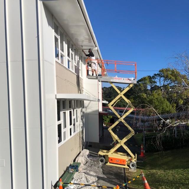 Exterior building scissor lift painting